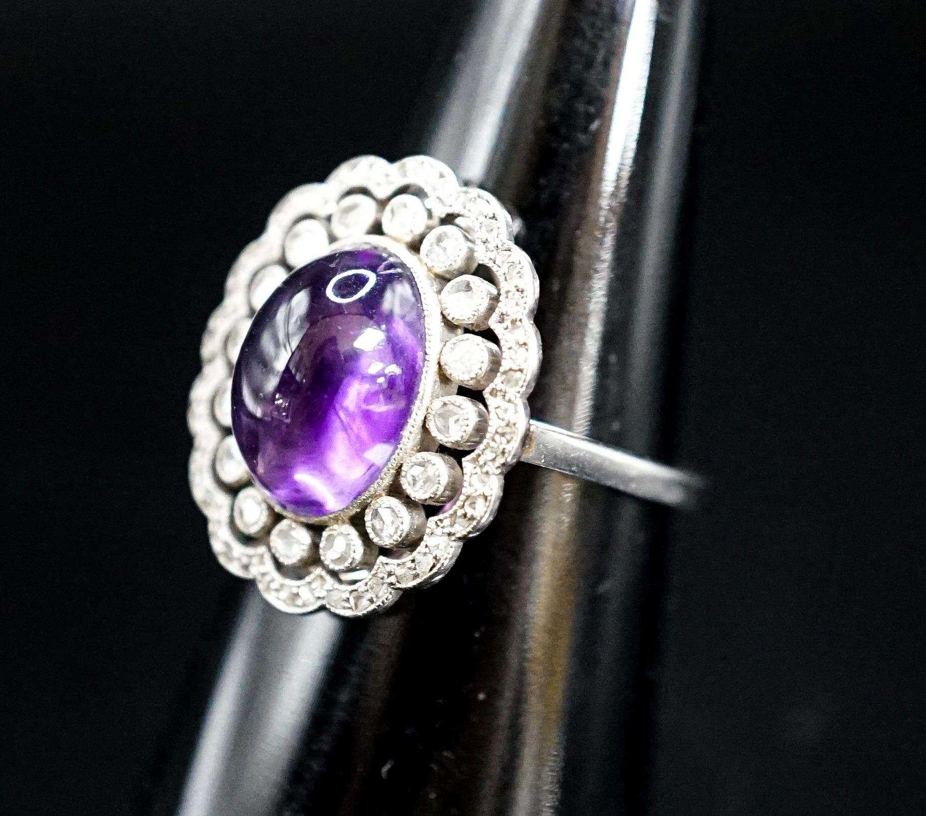 A 1920's white metal, cabochon amethyst and rose cut diamond ring, size M, gross weight 5.9 grams.